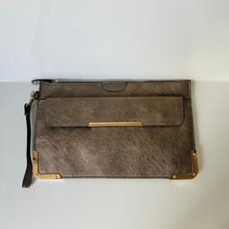 Dimensions are 20cm height x 30cm width. This clutch bag comes in a brown finish and has two storage compartments. One can be opened by using the zip whilst the other can be opened with the buttons.