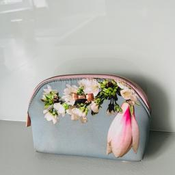 Dimensions are 10cm height x 15cm width. The makeup bag has a floral design on it. Can be opened by using the pink zip. It is authentic and in mint condition. Has a cute little Ted Baker bow on it and the T zip.