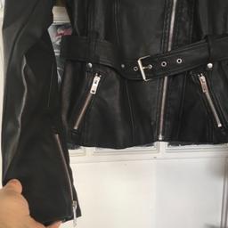 Item description
This is a faux leather but a expensive one I paid
£135
Little pleats at back and the belt clips in see pics
Size 14 but please check the measurements
Underarm to underarm is 36 inches
Waist at belt is 32
Across the shoulders is also 32
So think this would fit a 12 better 
Cash on collect from b37area Birmingham
