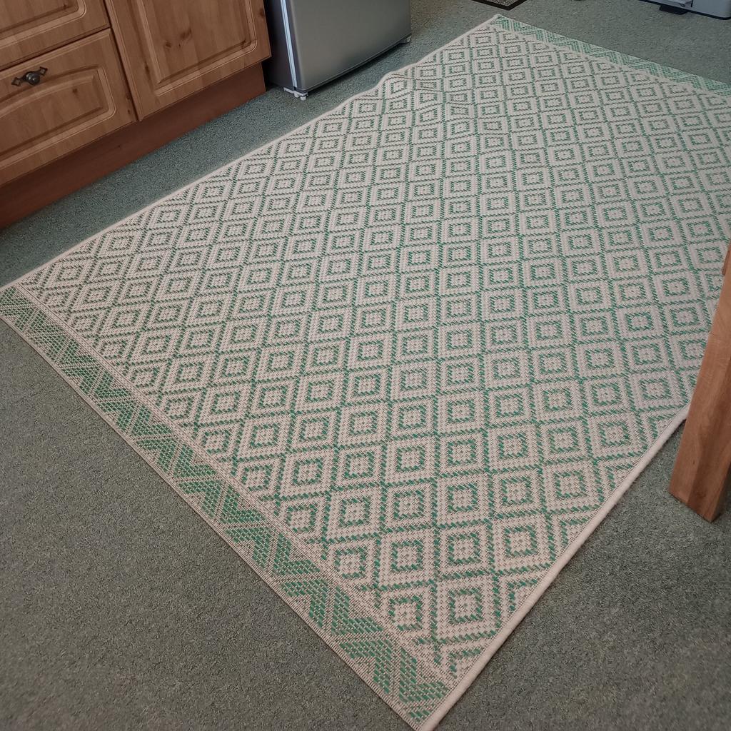 This is a really nice Rug which can be used in any room. The size is 6 1/2 ft x 4 1/2ft or 80inch x 56inch. in a Green and Beige colour.