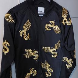 Adidas x Jeremy Scott Wing Dollar Tracktop
Brand new without tags
100% Genuine & Authentic
Never been worn
Size: Small
Colour: Black & Gold
Allover wing dollar embroidered logo in Gold
Ribbed Neck, Cuffs and Hem
2 front zip pockets and full front zip closure
Deadstock - really rare to find in this condition.

*Please be assured this is size: Small, even though, it doesn't indicate sizing, on the inside of the tracktop.*

Only genuine buyers, no derogatory offers please!!!

No returns accepted!!

COLLECTION & CASH ONLY!!!!
