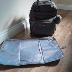 Grey baby bag/rucksack, with changing mat.
Plenty of pockets and bottle spaces, detachable zip bag ideal for dummies 
front pocket has a clip for keys, so you don't lose them.
Excellent for travelling about, fits everything in.