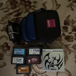 Silver (Tribal)Nintendo Gameboy Advance SP Console in good condition,comes with original charger, pouch with three compartments,and five games cartridges which one has got two games on ie Finding Nemo and The incredibles/The Simpsons Road Rage/The Sims 2 /The Wild Thornberrys Movie/Fila Decathlon/
