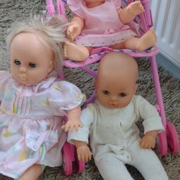 three dolls, one cries, one wets, an one normal, three extra outfits and a pushchair. pushchair folds flat for storage and transport