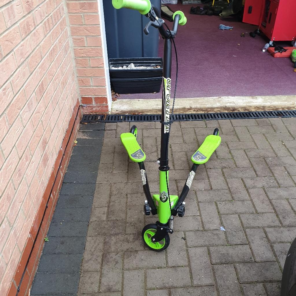 In excellent condition
Front brake to stop it .
Folds down to store has velcro strap to secure it to transport.
Son outgrown it Now
Bargain was 89.99
ideal xmas present as in excellent contion still

Sporter is a different kind of scooter which works without having to place your feet on the floor
The large 120mm rear wheels are designed to swing freely. By simply twisting your hips from side to side (similar to a skiing movement) Wriggler will propel forward without ever having to pedal or touch the ground It's a great low-impact exercise and great for building strength on legs, body coordination and balance
Sporter is foldable for easy storage and features a cable front brake,
The handlebar height is adjustable too so will grow with your child. Within a short space or time, your child will master drifting & sliding
Sporter is ideal for 4 year olds upwards but always check the handlebar height is suitable for your own child as they are all different