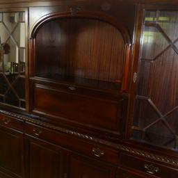 Mahogany affect wall unit, splits into two pieces. Had glass shelves and mirror in the drinks cabinet. It also has a light. There's lots of room for storing things and a cutlery draw. Approxmate size Height 183cm,length 183cm depth 36cm.
In very good condition.
Buyer Collects, only.
