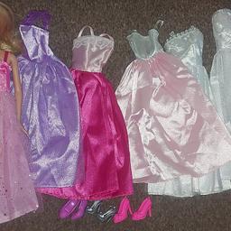 Barbie doll with 6 dresses and 3 pairs of shoes