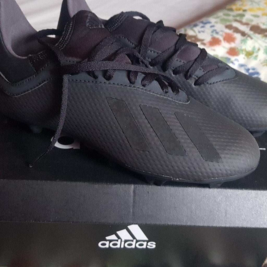 Brand new. Still in box Adidas football boots. Never worn Adidas design with black laces. Excellent condition .uk. kids size 4