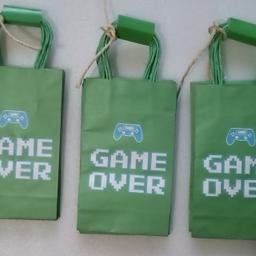 Game Over/ Gamer Birthday Bags/Video Favor Bags/Video Treat Bags.

24 Theme Party Paper Gift Bags with Handles 9 x 4 x 3 inches approx.

Kids and adults of all ages will light up with joy once they receive a party favor bag full of goodies.  Are ideal for handing out to guests during an upcoming sports birthday after party.

Local collection preferred or can be posted out at extra costs.