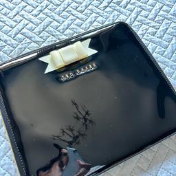 Great condition

Technically an iPad case but was only ever used as a clutch bag

Black patent with cream plastic bow and gold hardware

Dust bag included

On other sites

Will deliver free locally