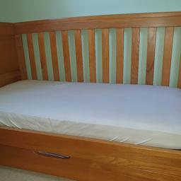 Mamas and Papas golden oak solid cotbed. I do have the other side safely stored away, this is a picture taken in bed style. Very solid, good condition piece of furniture. Welcome to view before you buy