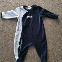 Dress up your little boy in style with this stunning velour sleepsuit from the house of HUGO BOSS. This blue outfit/set is perfect for winter season and comes in size 3-6 months. Designed to make your baby boy look his best, this velour sleepsuit boasts of a unique character that adds a touch of elegance to his wardrobe.

Crafted from high-quality fabric, this Hugo Boss sleepsuit not only looks great but also ensures your baby's comfort. So, get your hands on this amazing outfit/set and give your little one a perfect gift that he will cherish forever

Worn only once.