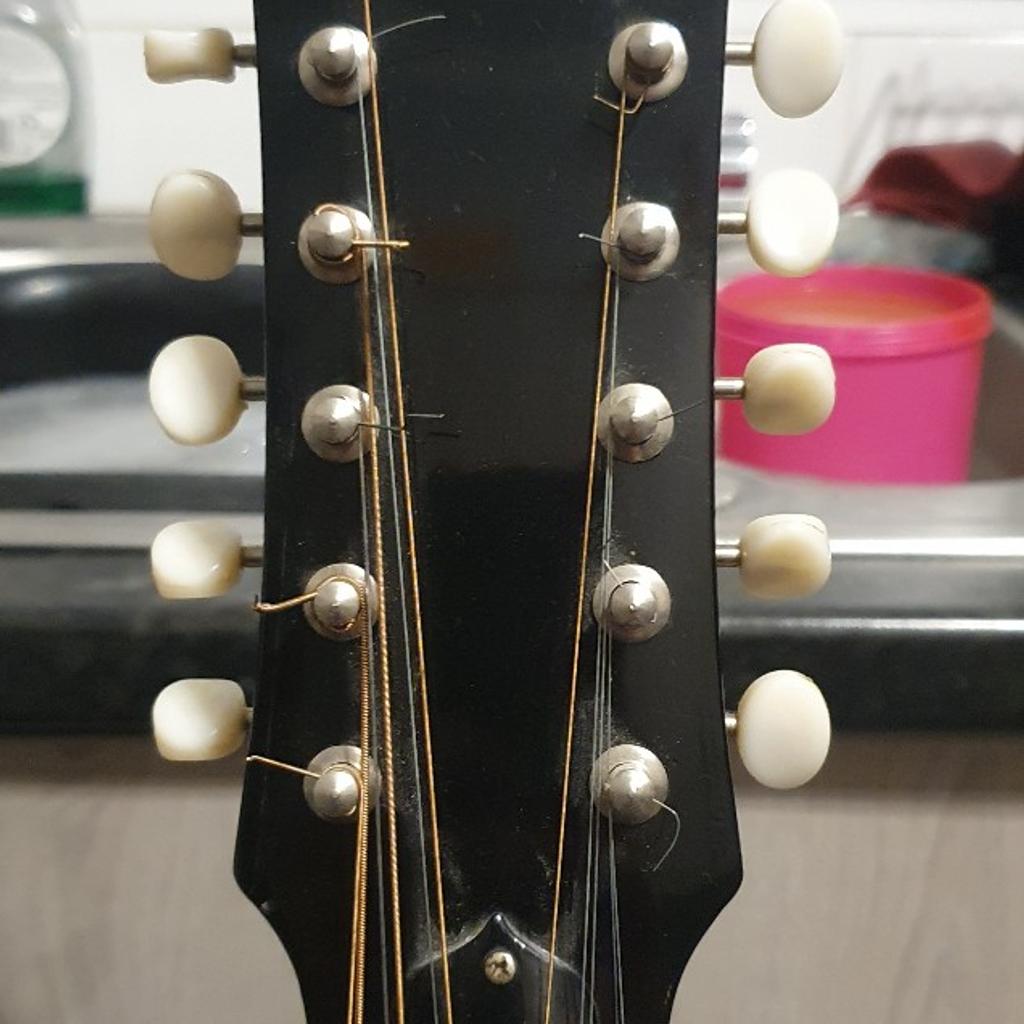 I've had this parlour sized vintage guitar around 30 years. I bought it with the little dent on the back, and intended to have it repaired, but it didn't make any difference to the guitar so left as is.

It has a few lacquer cracks on the top due to the age of it, but just adds to the mojo. It's completely original, tuners are a little stiff but completely usable and still hold the tuning very well.

The back is an arch style that helps
project the sound, and internally it is ladder braced.
