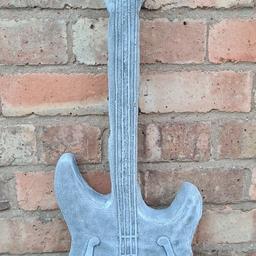 An unusual Item. Guitar with hook to hang it up. approx 30 inch long. Made in concrete. Billesley B13 or delivery possible for cost of fuel