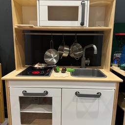 Kids wooden kitchen for imaginative play. Includes interactive hob, pots and pans. 

Play food and shopping basket included. Additional cutting fruit (magnetic & Velcro bought separately) included.