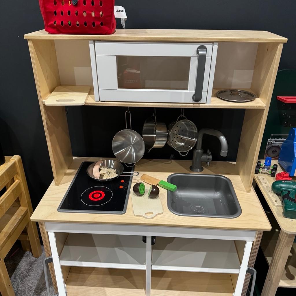 Kids wooden kitchen for imaginative play. Includes interactive hob, pots and pans.

Play food and shopping basket included. Additional cutting fruit (magnetic & Velcro bought separately) included.