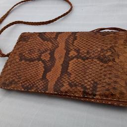 Vintage Genuine Snakeskin Envelope Purse Leather Shoulder Strap Handmade.

Bag Depth 5"
Bag Width 10"
Lining Material Cotton
Bag Height 6"

Listed as new as vintage with no rips, tears or visible damage.  You would definitely stand out with this timeless accessory as others are faux.

Local collection preferred or can be posted out at extra costs, signed for.