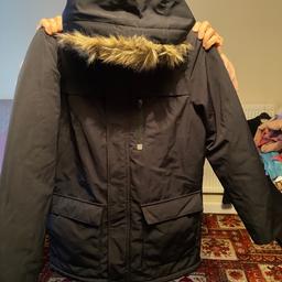 Warm boys quilted coat age 14 years, fitted hood, with fur trim, 1 large zip up pocket and 2 large popper button pockets, broken zip but can still use popper buttons to fasten close. Great condition, lovely winter coat.