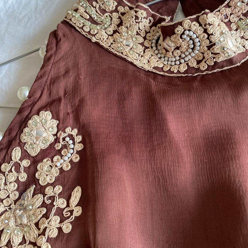 Brand new sleeveless dress in a different elegant shade from designer Saiqa Majeed. Beautiful cream embroidery across front and exclusive pearl button design at the back. In quality chiffon material. Comes with cream trouser with brown embroidery. Offers welcome!
I can post for £4 extra.