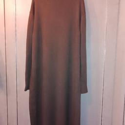 new long knitted dress lovely soft feel has stretch to it one size will fit upto a size18 nice and warm for cold weather put a leather belt with it looks great on is like a toffee colour. can be collected. polyester and elastane