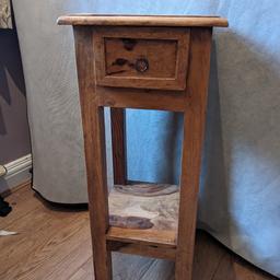 lovely looking dark wood side table with draw. very good condition. height 2.5ft, width and depth 1ft.