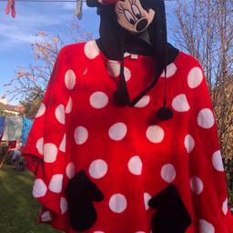 Gorgeous Disney Minnie Mouse poncho. Red and black fleece poncho with the cutest Minnie Mouse hood Pom Pom ties and pockets to the front. Make a great gift . Lovely item. One size fits all.