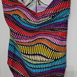 Brand New 
Elevate your swimwear game with this stunning multicoloured swimsuit in size 16. The bralette style top with halter straps and built-in bra offers ample support while the swim briefs provide the perfect coverage. The geometric pattern adds a fun touch while the polyester and elastane material make it machine washable for easy care.
Perfect for any water activity, this one-piece swimsuit is a must-have addition to your wardrobe.