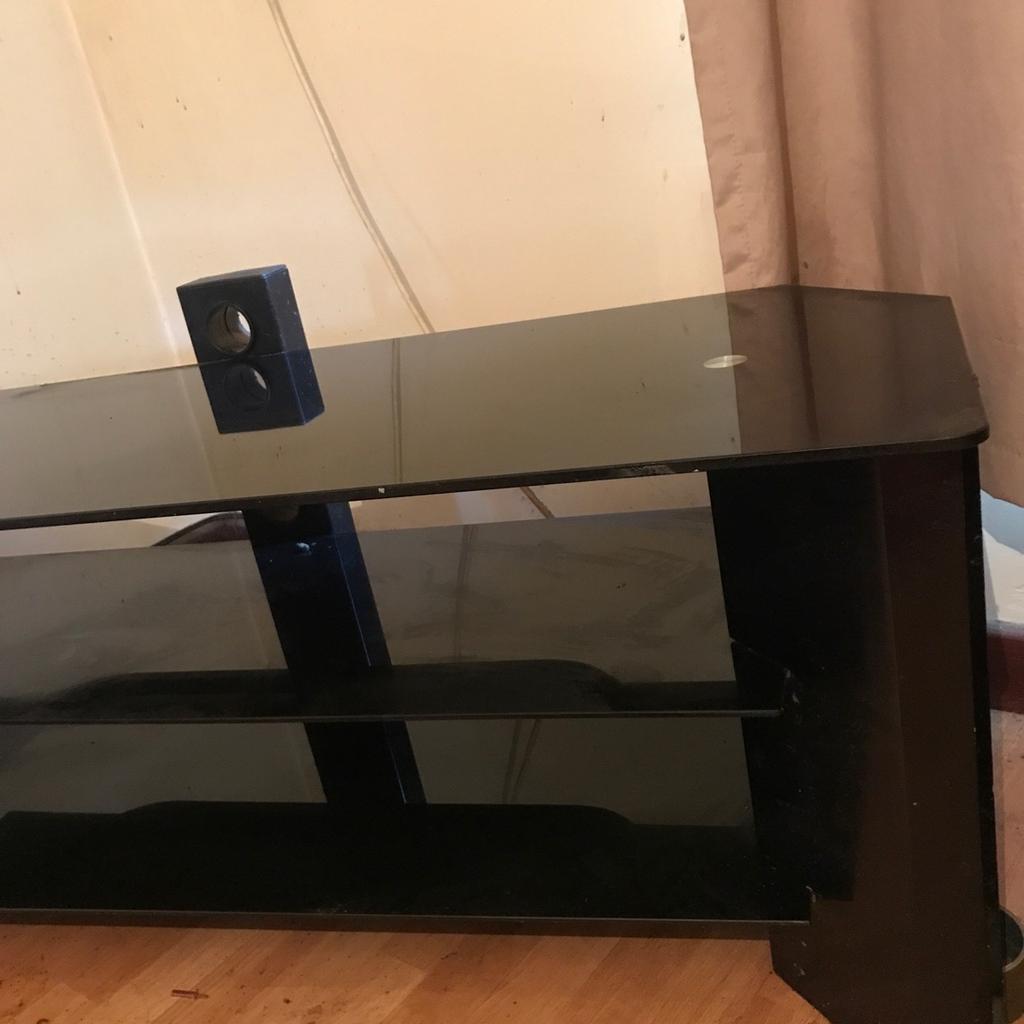 Large solid black glass tv stand no wear or marks at all comes apart easily with slots and goes back together easily 3 shelves altogether very solidly built very stable. Their is no screws or nails needed it all just slots together so it’s very easily took apart if you wanted to move it in a small area then it can be taken apart easily put in a box move it then put it bk together with your hands only it very easily all slots together so if you want to purchase this then I could have it put together or I could take it apart and package it so it’s easier to move takes less space then you could slot it together yourself I can have it ready either way