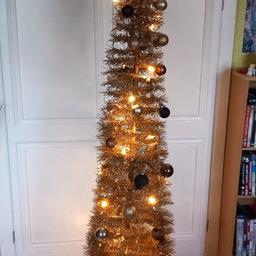 gold colour 
pop up Christmas tree 6ft with lights in brand new condition.
with other bits shown.