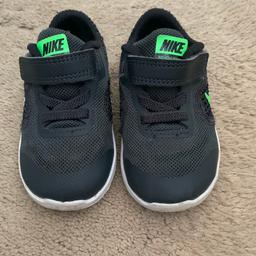 Boys Nike revolution trainers. Black with green logo. Good condition. Size 5.5.