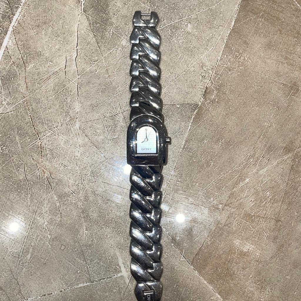 DKNY watch silver color trendy for females. Currently battery gone will need renewal