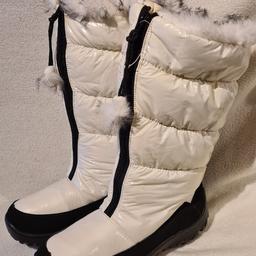 Faux fur lined snow boots. Brand new white uk5 in very good condition. Please read carefully. These are brand new snow boots but shop soiled in that there are so.me blue ink marks and other marks. See photos for condition size flaws materials etc. I can offer try before you buy option if you are local but if viewing on an auction site viewing STRICTLY prior to end of auction.  If you bid and win it's yours. Cash on collection or post at extra cost which is £4.55 Royal Mail 2nd class. I can offer free local delivery within five miles of my postcode. Listed on five other sites so it may end abruptly. Don't be disappointed. Any questions please ask and I will answer asap.
Please check out my other items. I have hundreds of items for sale including bikes, men's, womens, and children's clothes. Trainers of all brands. Boots of all brands. Sandals of all brands. 
There are over 50 bikes available and I sell on multiple sites so search bikes in
