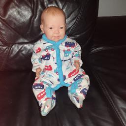 reborn doll for sale in good condition he wears new born clothes has painted hair and soft body.can be posed in different ways comes wearing a nappy and sleep suit and comes with spare clothes