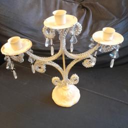 Lovely candle holder with crystal s hanging from it