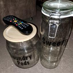 2 large glass jars from IKEA. Remote to show size. Were used for laundry pods and sweets as shown on the labels but they could be removed. 
Tall jar £3 and larger one £4.