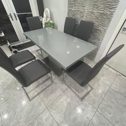 Grey dining table with six chairs mint condition no scratches no marks can go smaller and bigger size. PU FOR MORE INFORMATION