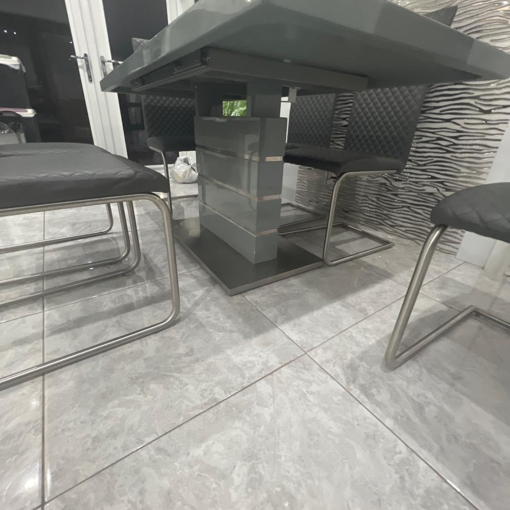 Grey dining table with six chairs mint condition no scratches no marks can go smaller and bigger size. PU FOR MORE INFORMATION