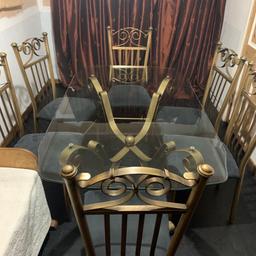 Quality large glass dining table length 152cm x width 92cm safety glass beveled shaped edge gold frame with six chairs with slate grey velvet padded seats may deliver
