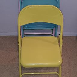 Four different coloured metal folding chairs. Green, yellow, blue and pink, brand new never used. By Habitat and sold in Argos.