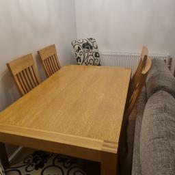 solid oak table .extends. cost over thousand pounds from Nettletons . 4 oak chairs plus 2 cream and black chairs .excellent condition well looked after . buyer to dismantle.