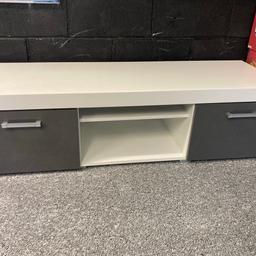 For sale is this white and Gloss grey TV unit.
Excellent condition.
Two pull down cupboards for storage along with central space for Sky, games consoles or DVD players.
Excellent condition and is a solid piece of furniture. 
Measurements are 140cms wide, 45cms deep and stands 39cms high from the floor.Priced to sell. Collection only please.