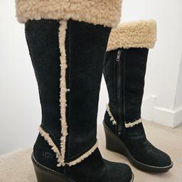 UGGs Australia Sandra Black Sheepskin Heel Boots

Beautiful knee-high boots from UGG Australia. Sandra black shearling wedge heel boots.
Excellent condition as seen in pictures!

• UK size 5.5
• Features a round-toe shape
• Mid-height wedge heel
• Sheepskin lining for added comfort
• Durable rubber soles make them perfect for any occasion. 
• Zip closure and fur lining, these UGG Australia Sandra boots are both stylish and functional.