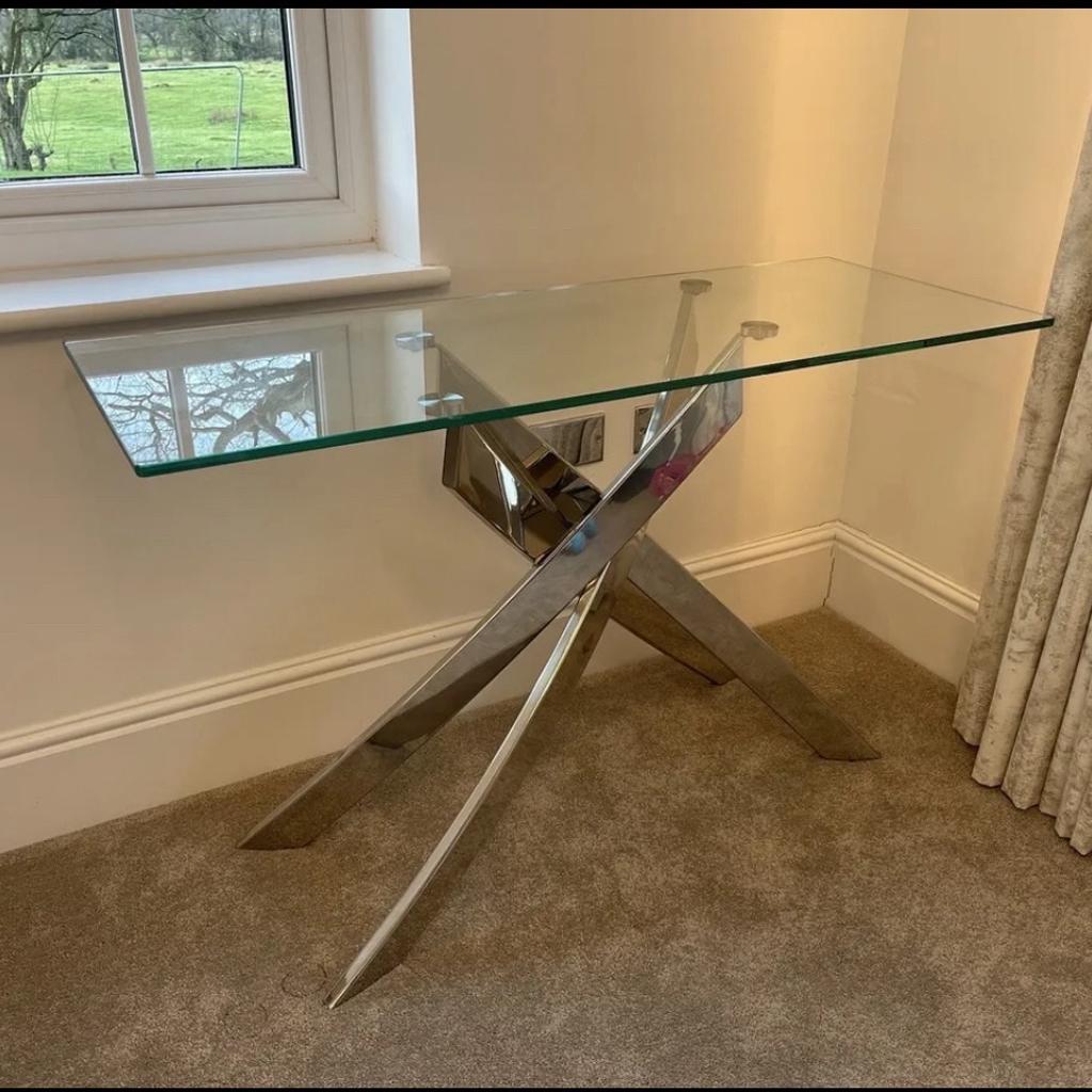 Glass Side Table with 4 intertwined crossed chrome legs.

Height 76.5cm
Depth 45cm
Width 120cm

Originally bought from Wayfair for £450

Solid build quality.

Collection only due to size and weight.

Location: Barrow BB7