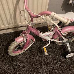 Girls Pink Bike with stabilisers a great starter bike for age possibly 4 to 8 yrs