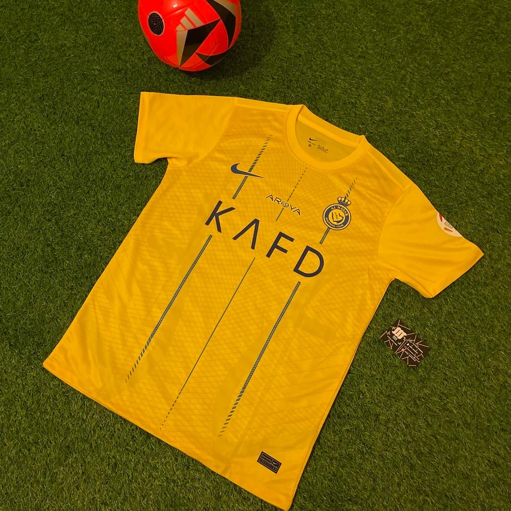 Show off your love for Al Nassr FC with this stunning home football shirt from the 2023/24 season. Made by Nike, this shirt is suitable for adults, featuring short sleeves that are perfect for playing football in. The shirt is in the club's iconic yellow colour, featuring the famous Al Nassr FC crest that is proudly displayed on the front.

This shirt is perfect for collectors and fans alike, with the added bonus of being match worn by Ronaldo. With its stylish design and high-quality construction, this shirt is a must-have for any football fan. Don't miss out on the chance to own a piece of football history with this Al Nassr FC home football shirt.

Available in all Men’s sizes.