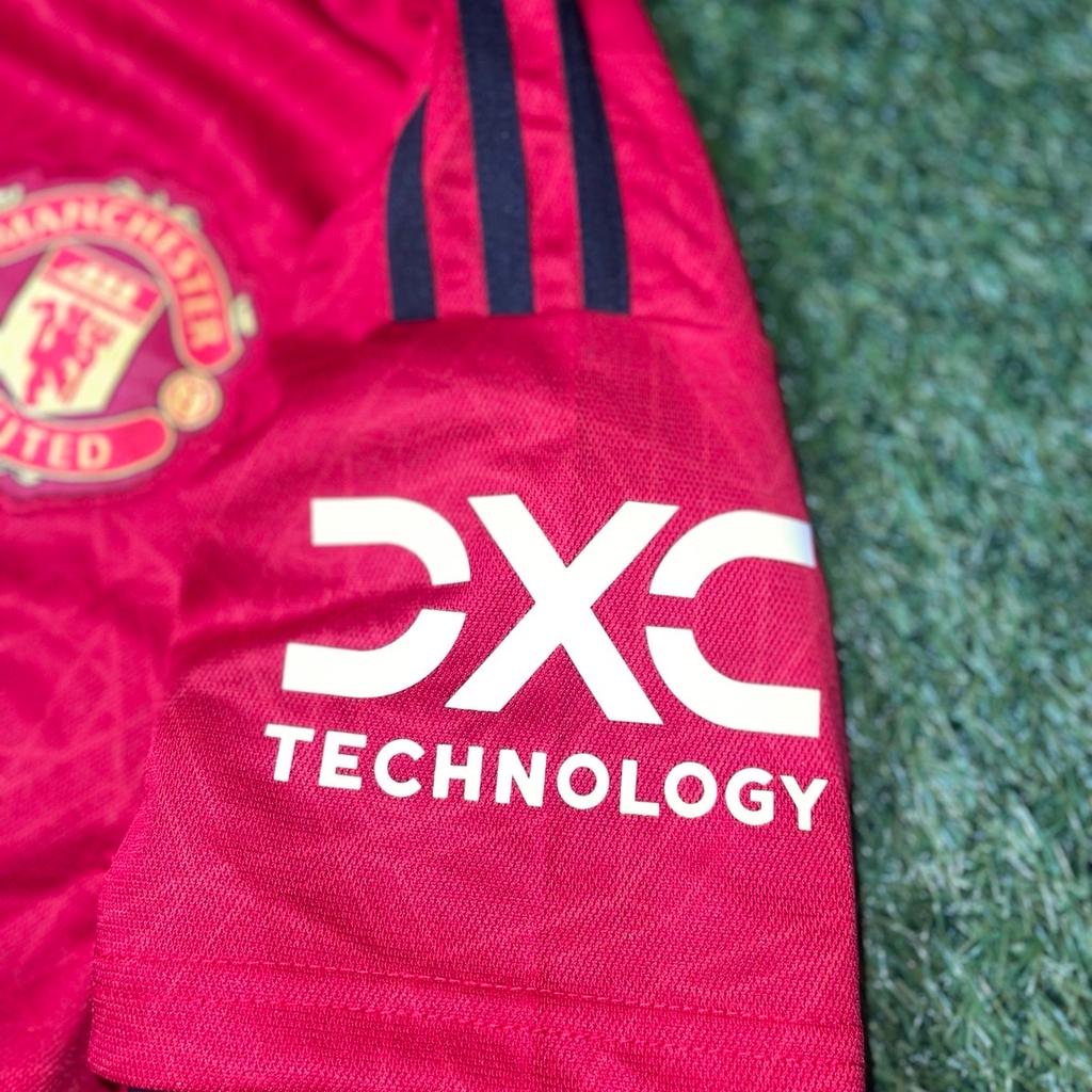 Show your support for one of the greatest football clubs in the world with this Manchester United 23/24 Home Shirt. The iconic red shirt is perfect for any fan looking to represent their favourite team. Made from high-quality materials, this shirt is designed to provide maximum comfort and durability. Whether you are heading to the stadium or watching the game from home, this shirt is the perfect way to show your support for Manchester United. Don't miss out on the opportunity to own this piece of football history.

Available in all Men’s sizes.