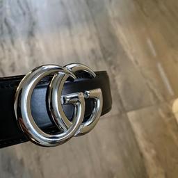 Elevate your wardrobe with this sleek and stylish men's belt from the renowned fashion house Gucci. Crafted from high-quality black leather, this accessory boasts a striking silver buckle featuring the iconic Gucci logo. Perfect for both formal and casual occasions, this belt is sure to make a statement and complete any outfit.

The size 46 waistband is designed to fit most men comfortably, while the Colour aspect allows for versatile pairing options. Whether you're dressing up for a special event or adding a touch of luxury to your everyday look, this Gucci belt is the perfect choice.