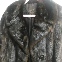A slightly fitted fur long coat in good condition. Very comfortable and warm especially in our climate now :)) I wore it with jeans or smart. It glosses black/brown. I have accumulated a few warm coats now selling as can’t wear all of them :)