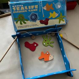 Wooden fishing game includes 2 magnetic fishing rods, 3 coloured fish (missing 4 others) and 4 wooden pieces to form a fishing area, comes with its own box.