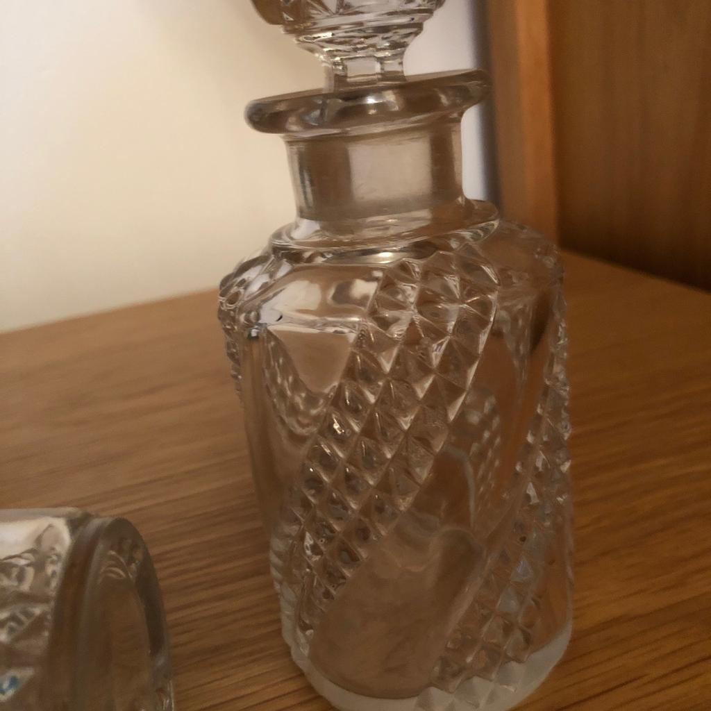 Lovely pair of vintage glass perfume bottles 15 cm both with stopper lovely pattern. In good condition. Thanks